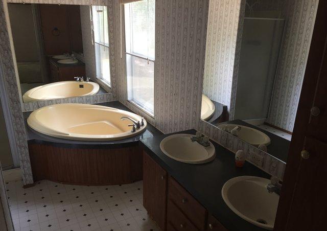 6146 Lake Ella Road Crestview, FL 32539 - Photo 7 of 12 a bathroom with a sink a toilet and a mirror