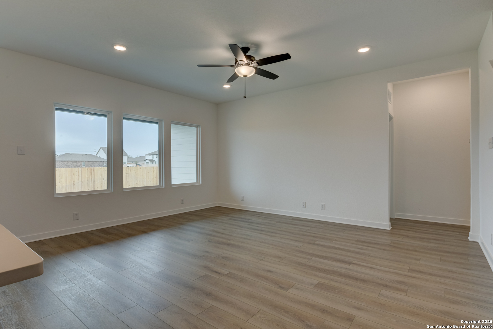 12848 Red Apple Road Schertz, TX 78154 - Photo 14 of 37 a view of an empty room with wooden floor and a window