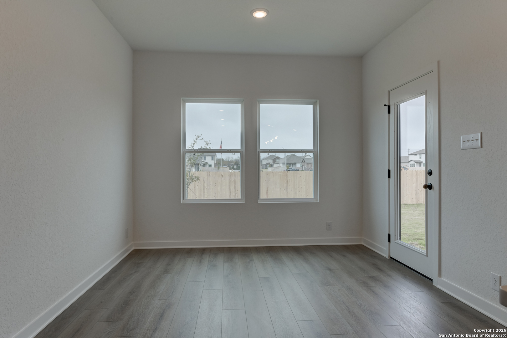 12848 Red Apple Road Schertz, TX 78154 - Photo 15 of 37 an empty room with wooden floor and windows