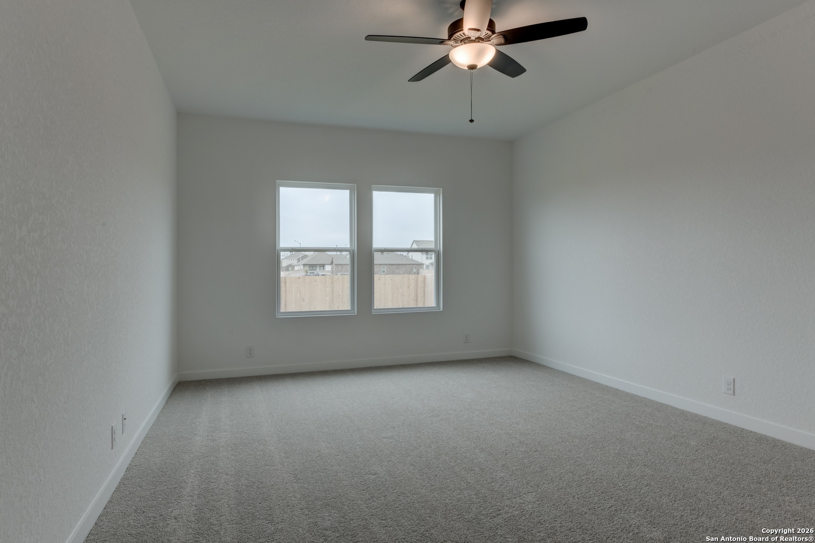 12848 Red Apple Road Schertz, TX 78154 - Photo 16 of 37 an empty room with windows and fan