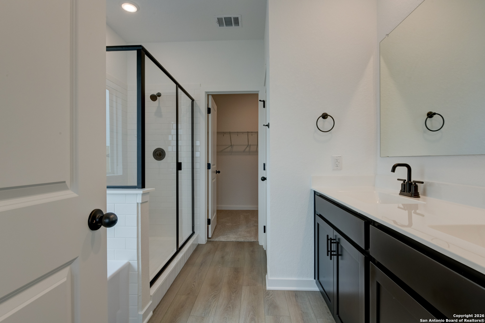 12848 Red Apple Road Schertz, TX 78154 - Photo 18 of 37 a bathroom with a double vanity sink a mirror and shower