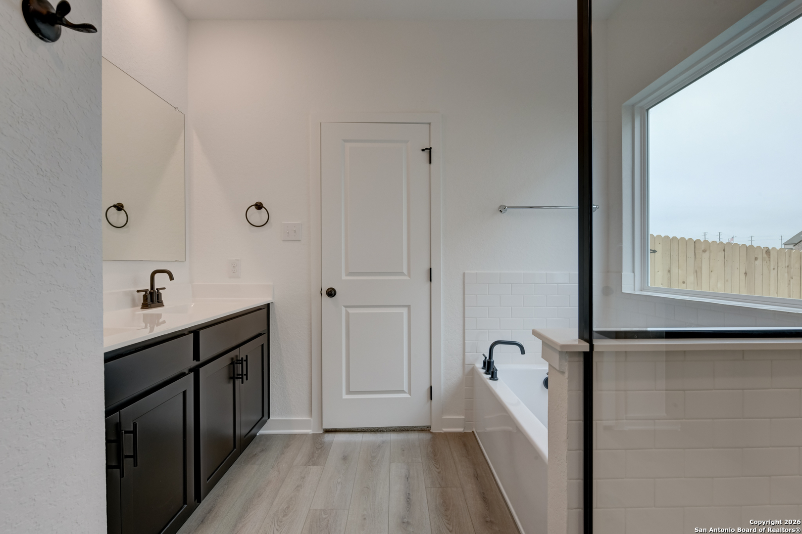 12848 Red Apple Road Schertz, TX 78154 - Photo 22 of 37 a view of a bathroom with a tub and shower