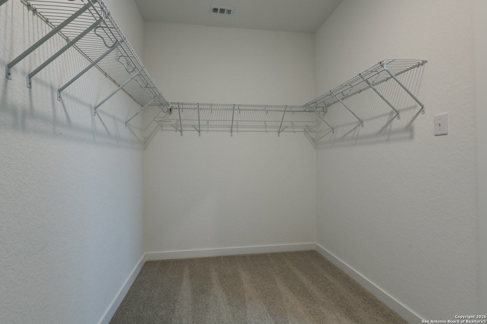 12848 Red Apple Road Schertz, TX 78154 - Photo 23 of 37 a view of a room with racks on the wall