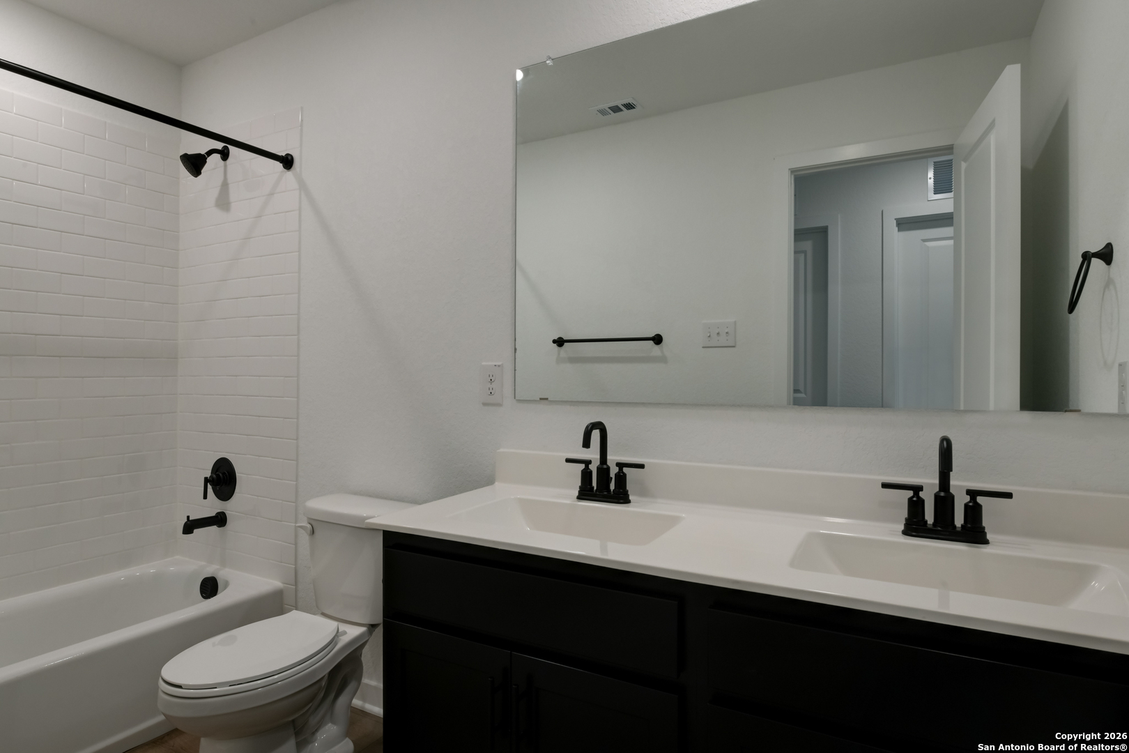 12848 Red Apple Road Schertz, TX 78154 - Photo 29 of 37 a bathroom with a sink a toilet a mirror a bathtub and shower