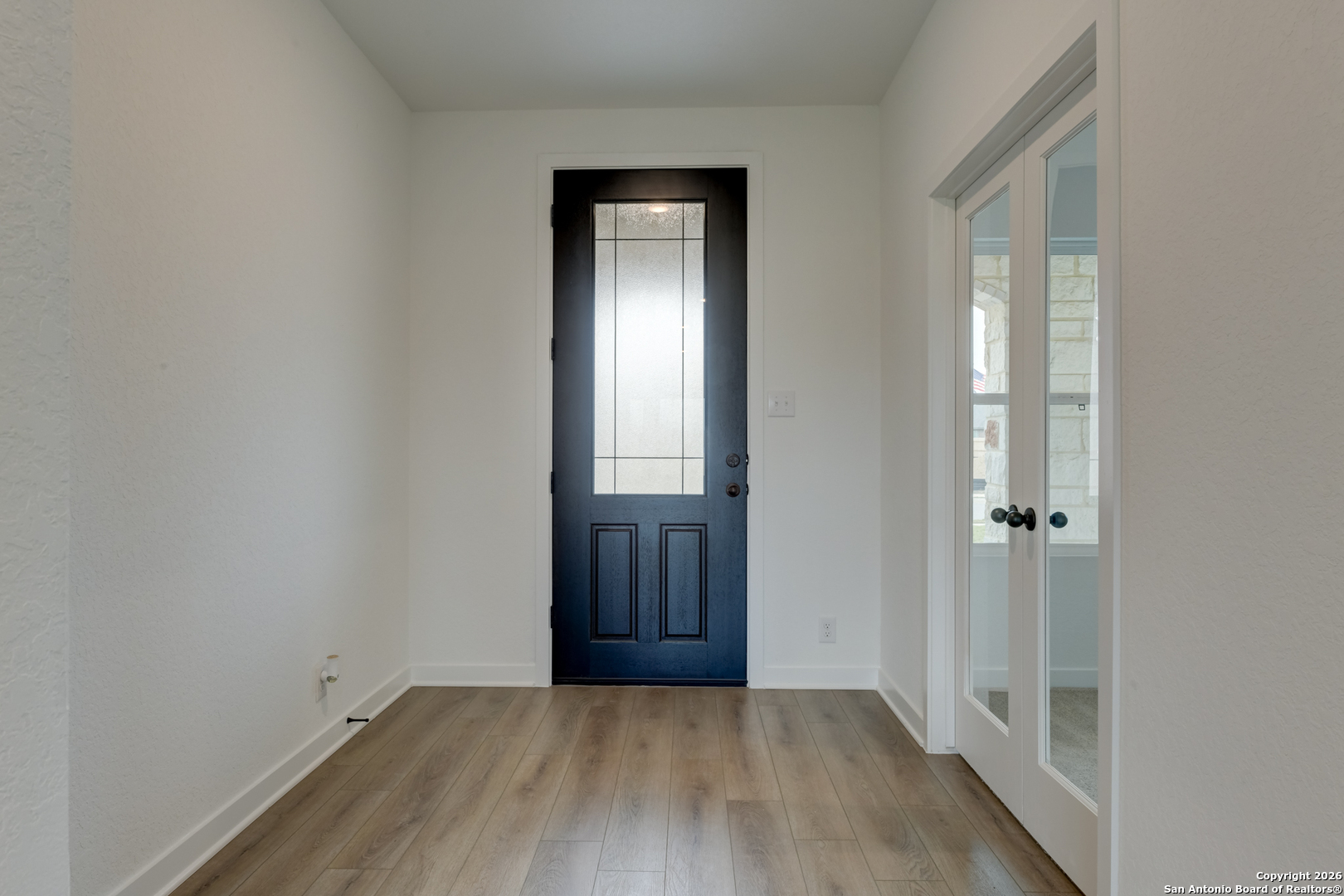 12848 Red Apple Road Schertz, TX 78154 - Photo 5 of 37 an empty room with wooden floor and a window