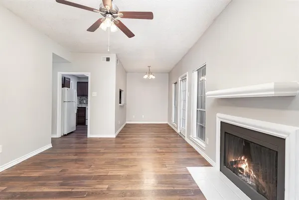 a view of hallway with wooden floor and fireplace