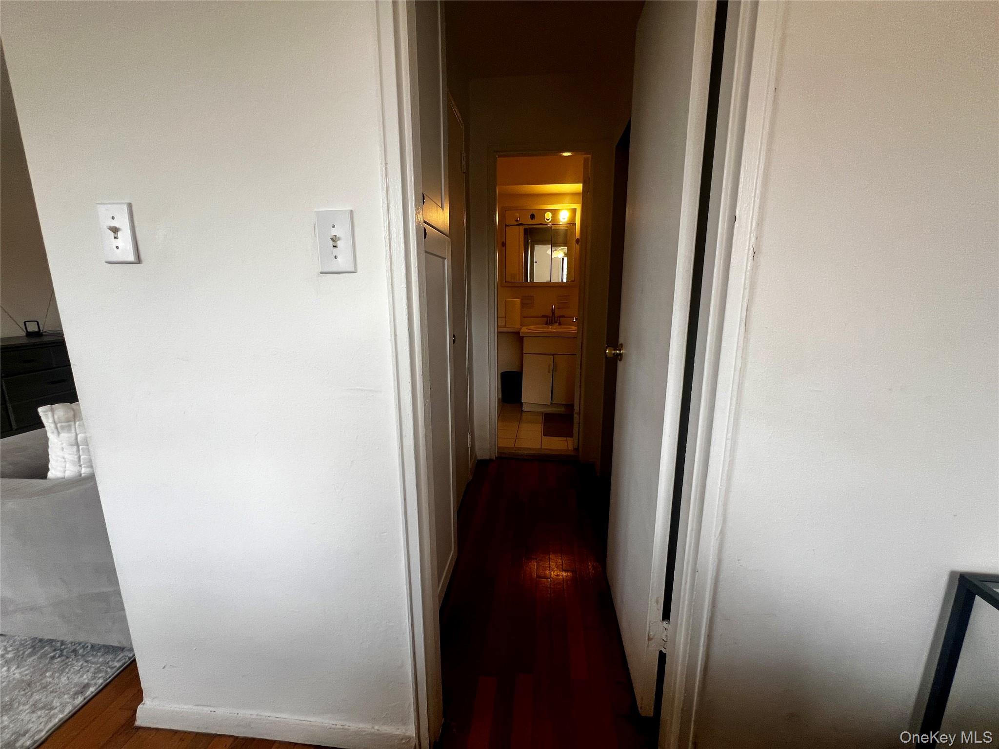84-29 155th Avenue, Unit 2H Queens, NY 11414 - Photo 19 of 38 Corridor featuring dark wood finished floors