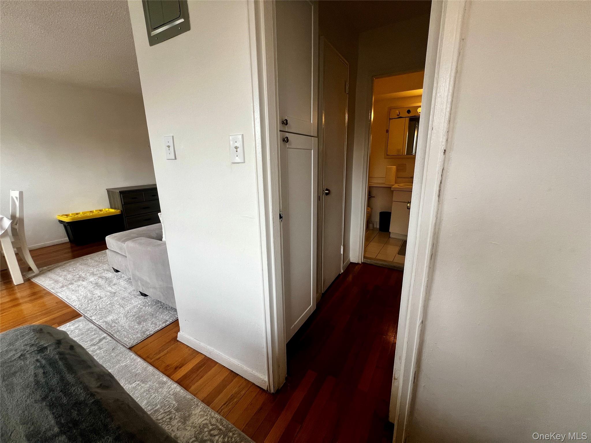84-29 155th Avenue, Unit 2H Queens, NY 11414 - Photo 20 of 38 Corridor with dark wood-style floors and a textured ceiling