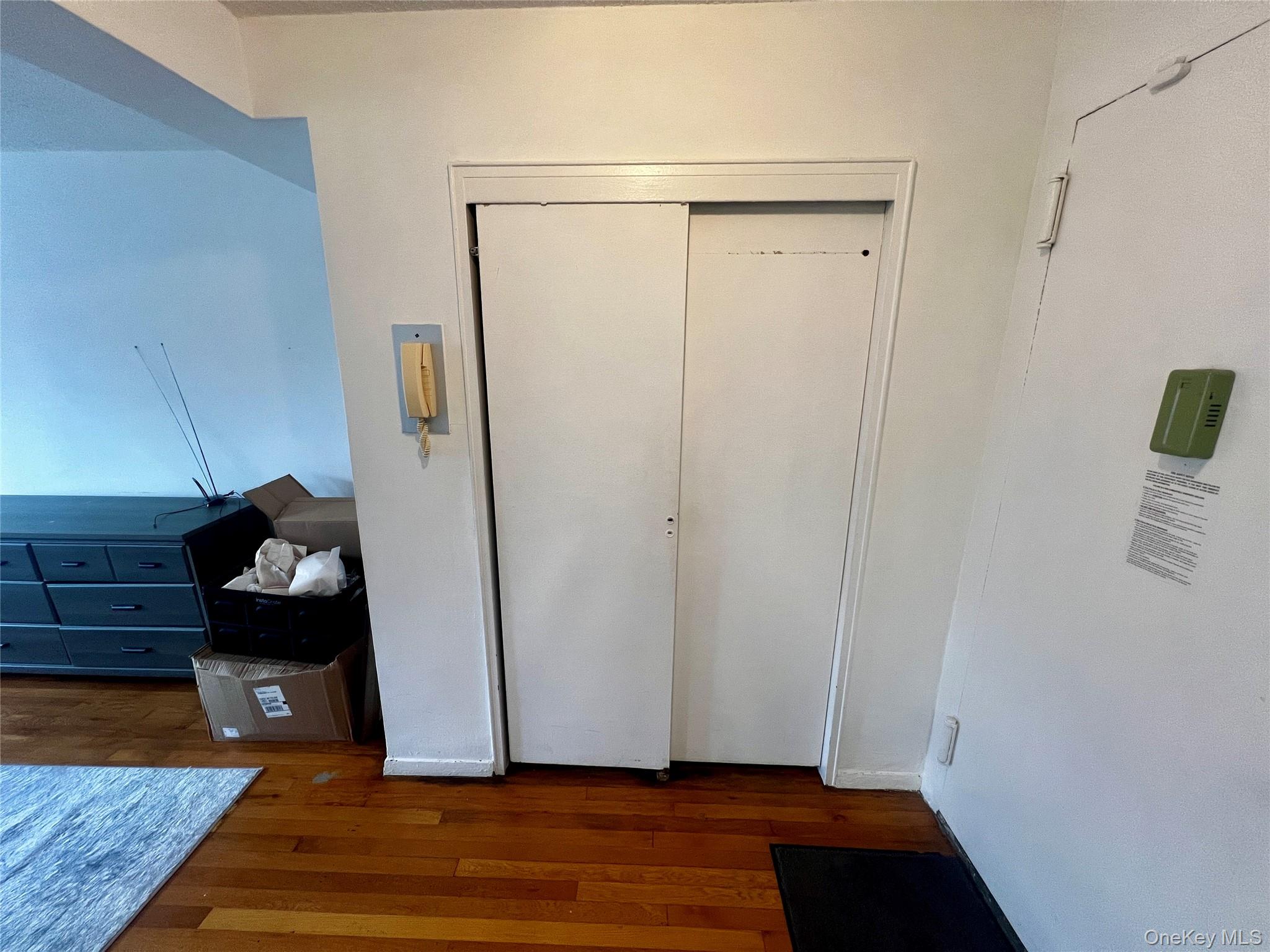 84-29 155th Avenue, Unit 2H Queens, NY 11414 - Photo 22 of 38 Unfurnished bedroom with a closet and dark wood-style flooring