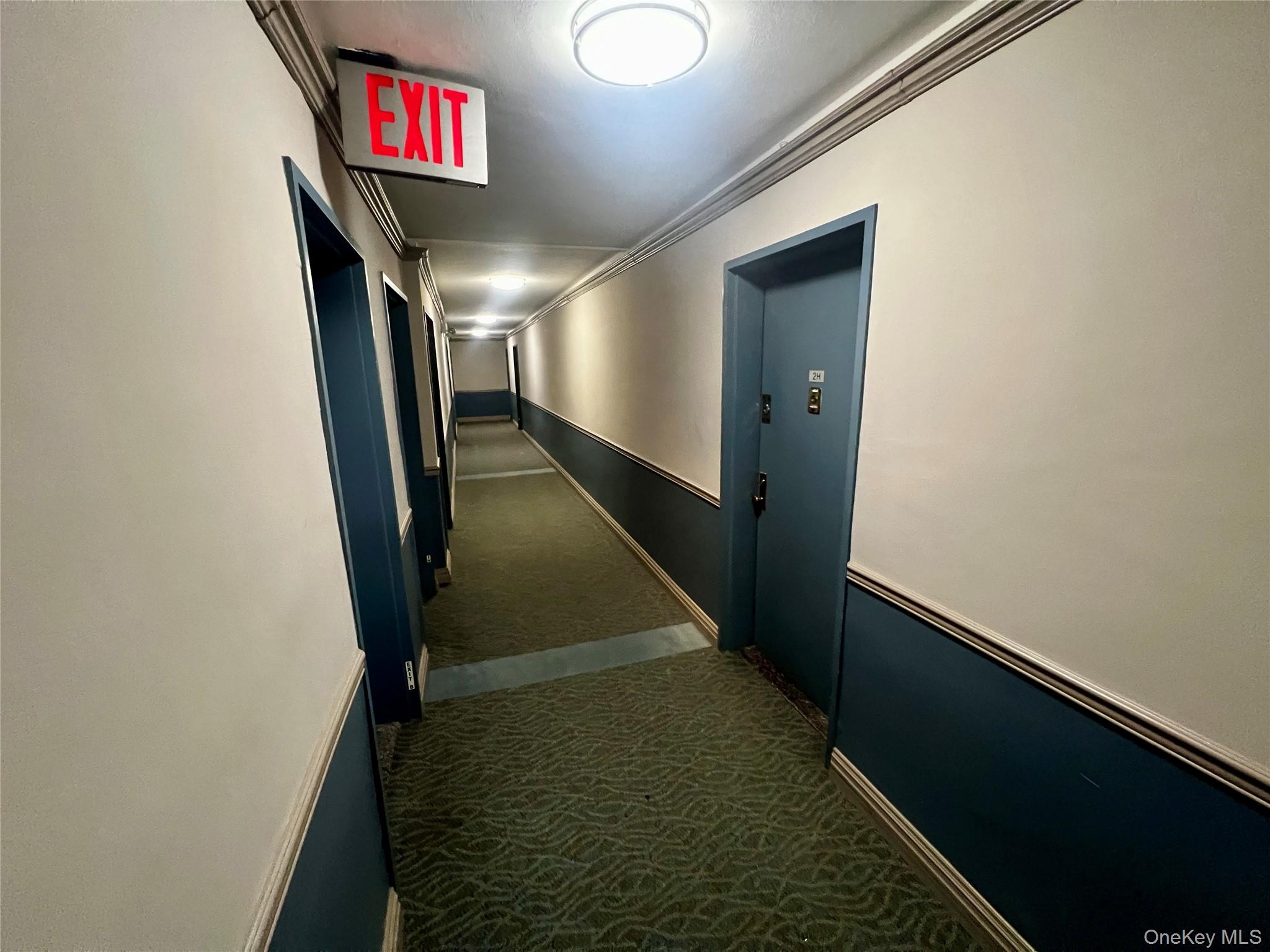 84-29 155th Avenue, Unit 2H Queens, NY 11414 - Photo 29 of 38 Corridor with dark carpet and ornamental molding