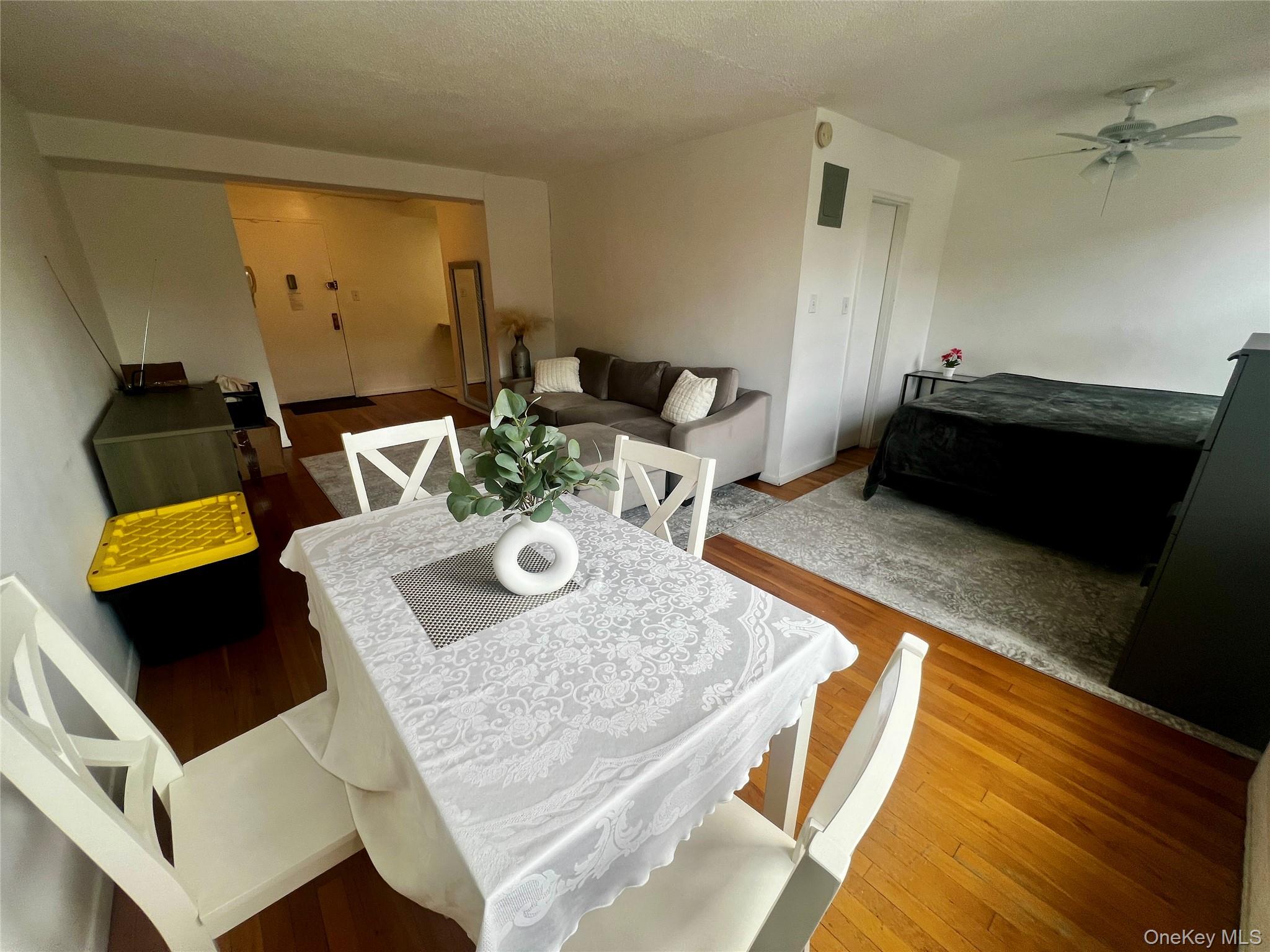 84-29 155th Avenue, Unit 2H Queens, NY 11414 - Photo 3 of 38 Dining space featuring wood-type flooring, a ceiling fan, and a textured ceiling