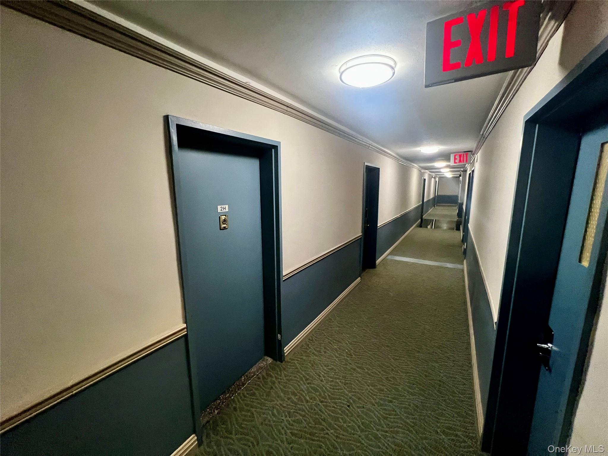 84-29 155th Avenue, Unit 2H Queens, NY 11414 - Photo 31 of 38 Hallway featuring crown molding and dark colored carpet
