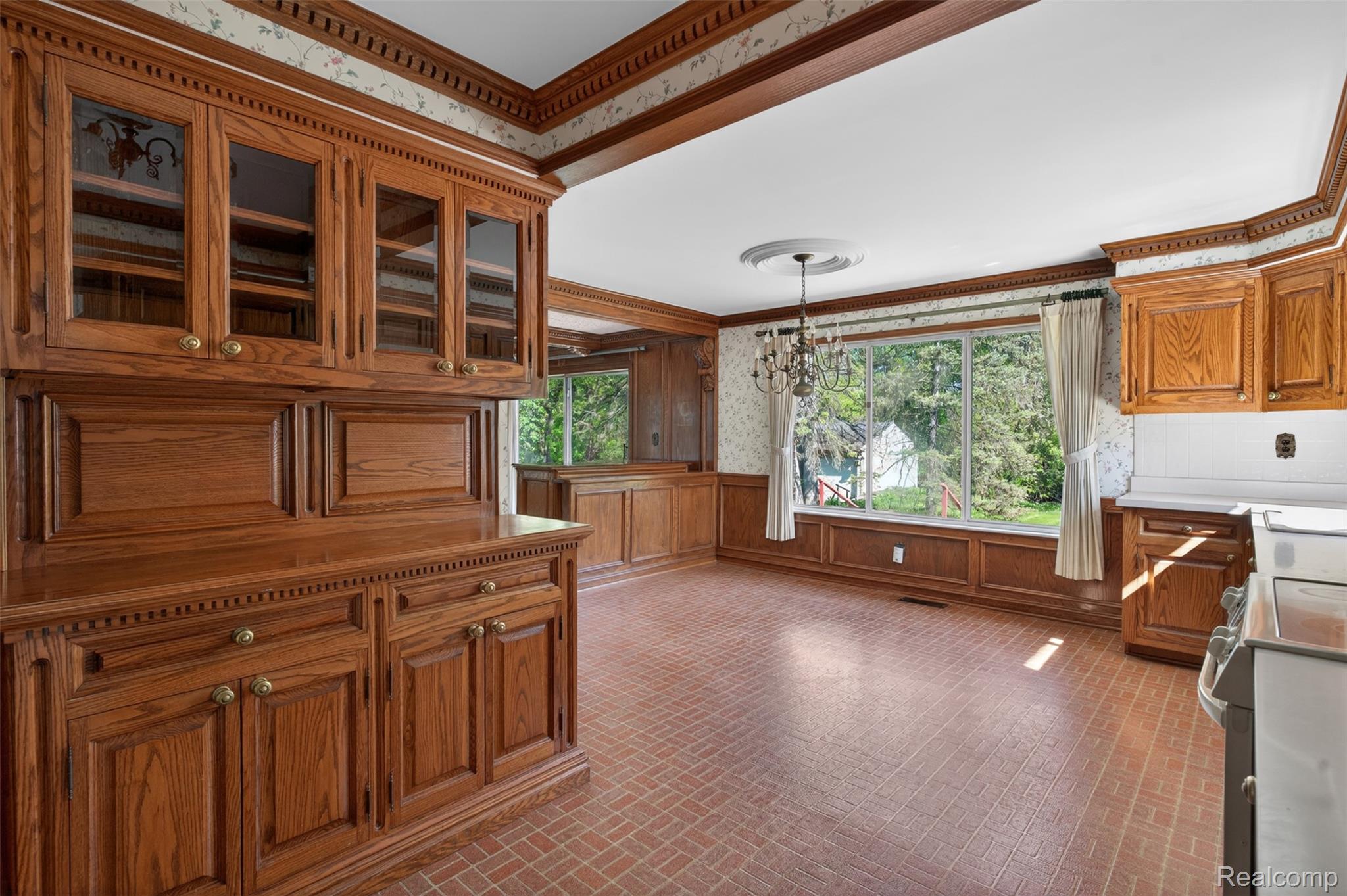 15623 Millar Road Clinton Township, MI 48036 - Photo 45 of 56 Kitchen with brick patterned floors, wood finish cabinetry, stainless steel range oven, wallpapered walls, and glass insert cabinets