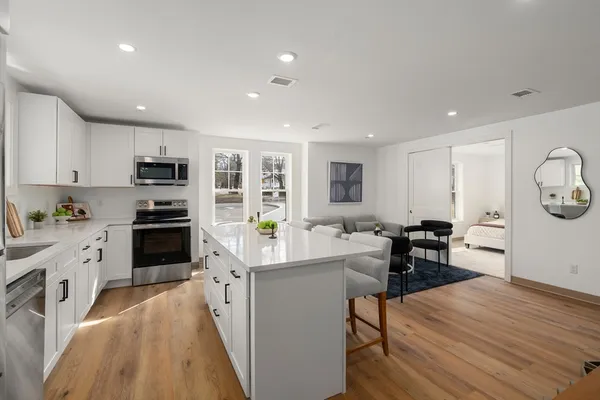 a kitchen with a sink a counter top space stainless steel appliances and cabinets