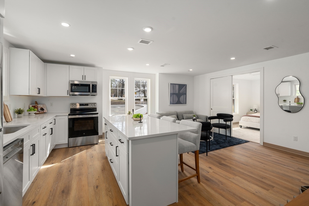 26 Union Street, Unit 306 Natick, MA 01760 - Photo 2 of 9 a kitchen with a sink a counter top space stainless steel appliances and cabinets