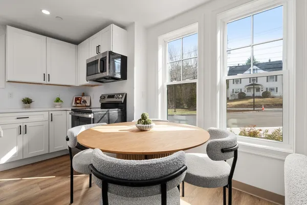 a dining room with furniture and window