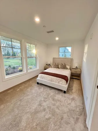 a spacious bedroom with a bed and a large window