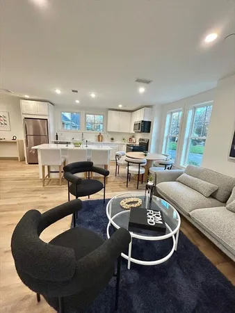 a living room with furniture and a dining table