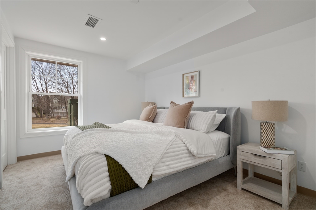 26 Union Street, Unit 306 Natick, MA 01760 - Photo 6 of 9 a bedroom with a bed and a window
