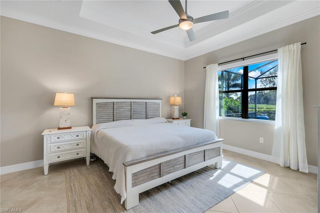 12832 Kinross Lane Naples, FL 34120 - Photo 12 of 45 Bedroom featuring a tray ceiling, ceiling fan, light tile patterned floors, and ornamental molding