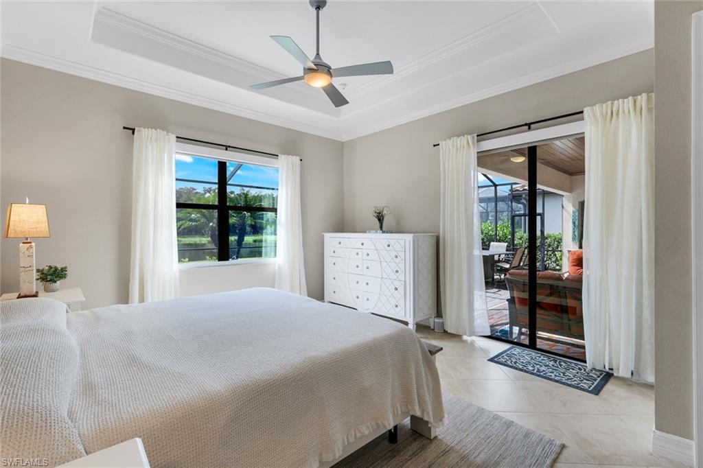 12832 Kinross Lane Naples, FL 34120 - Photo 13 of 45 Tiled bedroom with a raised ceiling, ornamental molding, access to exterior, and ceiling fan