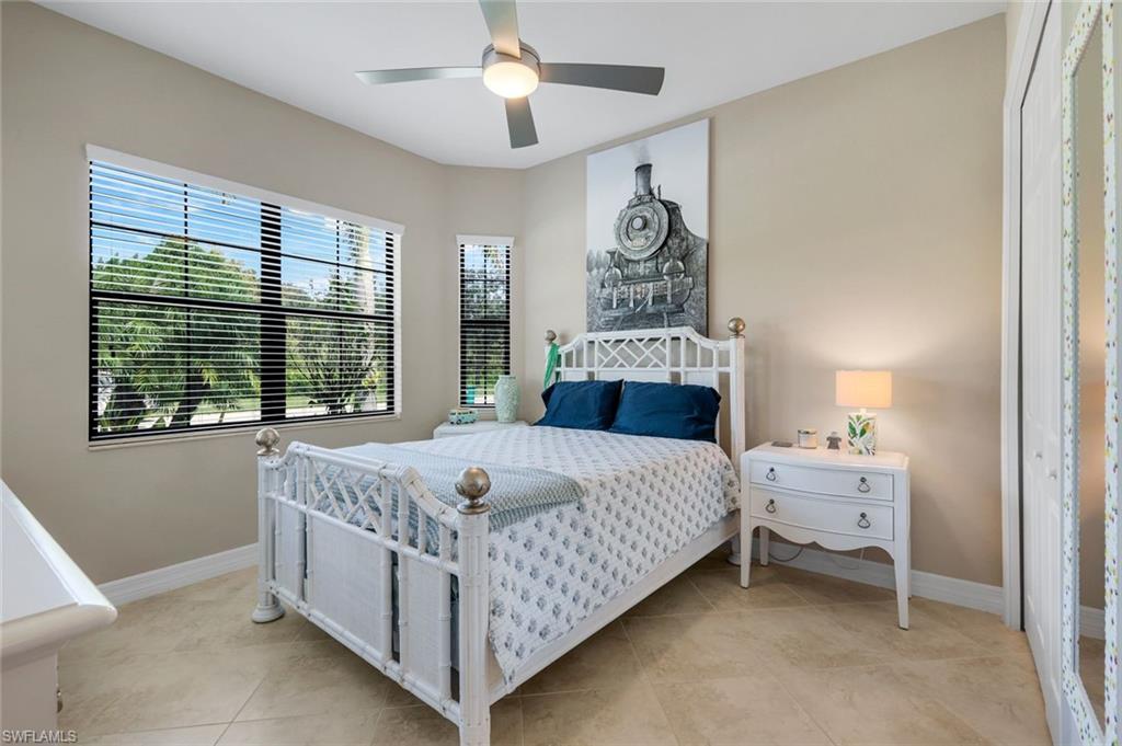 12832 Kinross Lane Naples, FL 34120 - Photo 16 of 45 Bedroom featuring ceiling fan, light tile patterned floors, and a closet