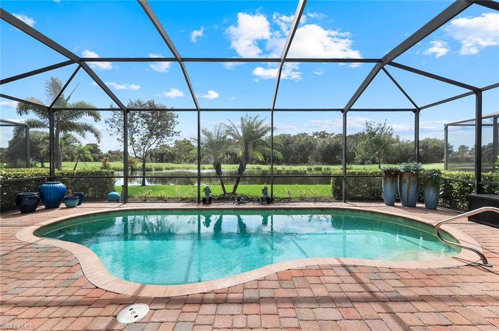 12832 Kinross Lane Naples, FL 34120 - Photo 21 of 45 Outdoor pool with a sunroom, a water view, glass enclosure, and a patio area