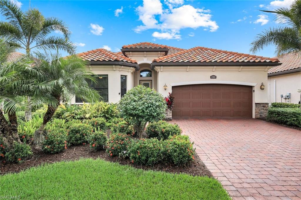 12832 Kinross Lane Naples, FL 34120 - Photo 22 of 45 Mediterranean / spanish-style home featuring stucco siding, decorative driveway, a tiled roof, and stone siding