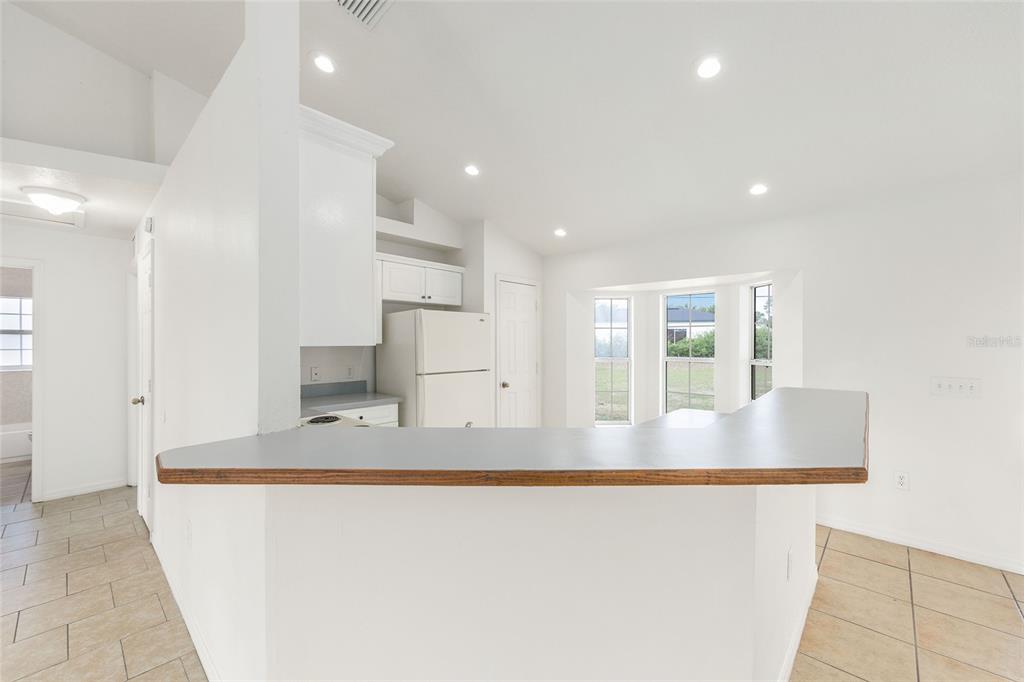 15434 Southwest 23rd Court Road Ocala, FL 34473 - Photo 19 of 41 a view of kitchen island a sink wooden floor and living room view