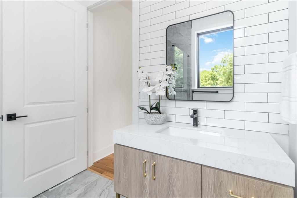 1554 Columbia Circle Decatur, GA 30032 - Photo 36 of 55 a bathroom with a sink and a mirror