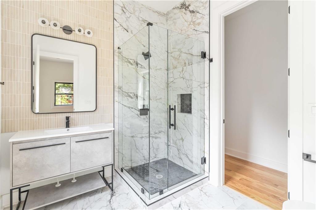 1554 Columbia Circle Decatur, GA 30032 - Photo 39 of 55 a bathroom with a shower a mirror and a sink