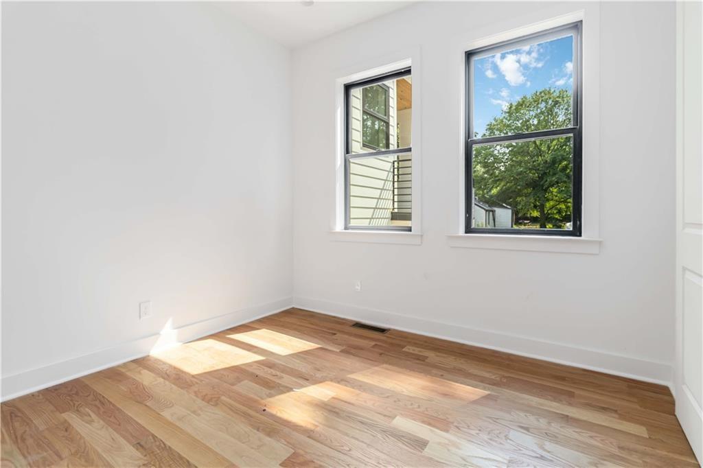 1554 Columbia Circle Decatur, GA 30032 - Photo 50 of 55 an empty room with wooden floor and windows