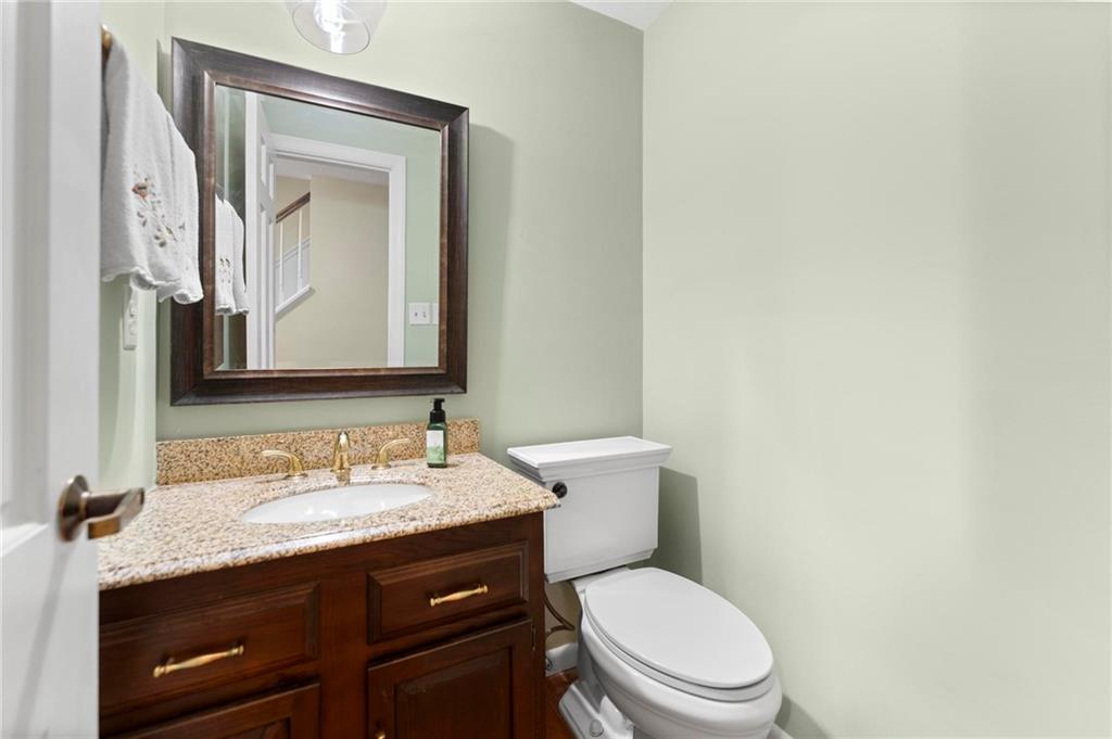 829 Ridgefield Avenue Pittsburgh, PA 15216 - Photo 24 of 50 a bathroom with a granite countertop toilet sink and mirror