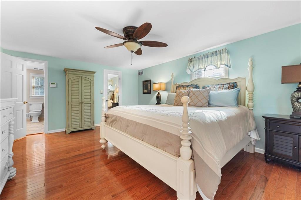 829 Ridgefield Avenue Pittsburgh, PA 15216 - Photo 25 of 50 a spacious bedroom with a bed and a chandelier