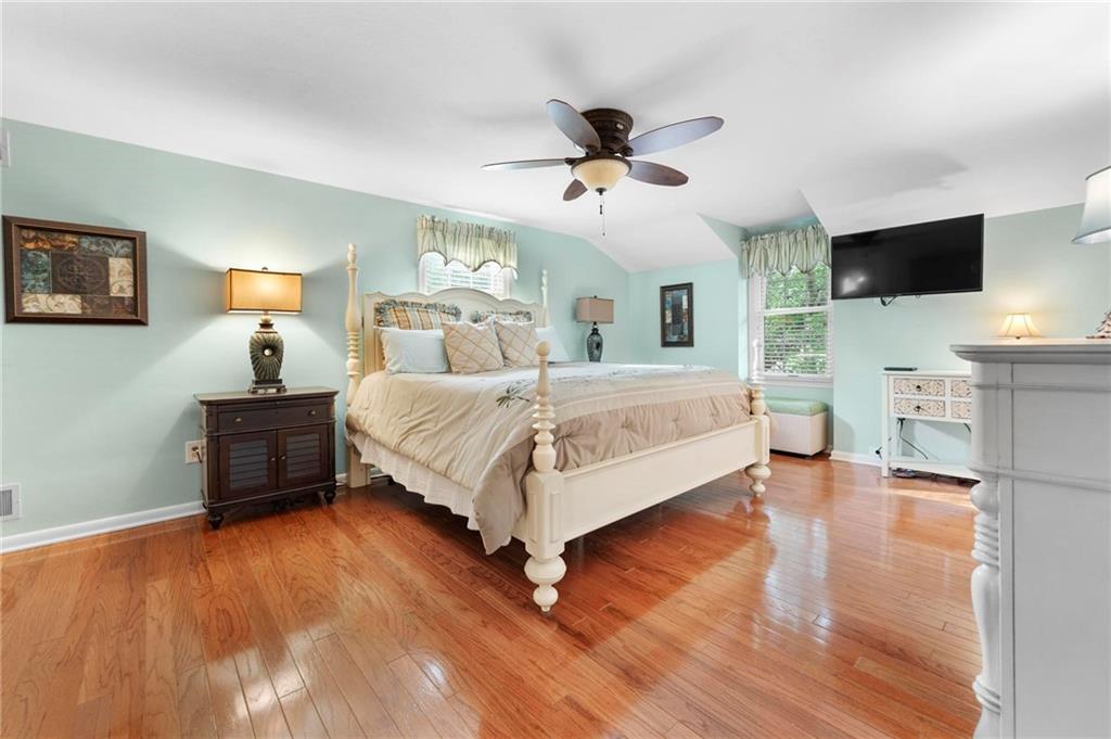 829 Ridgefield Avenue Pittsburgh, PA 15216 - Photo 26 of 50 a bedroom with a bed wooden floor and a flat screen tv