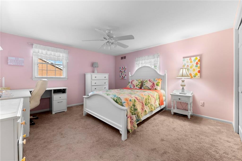 829 Ridgefield Avenue Pittsburgh, PA 15216 - Photo 29 of 50 a bedroom with a bed and a chandelier