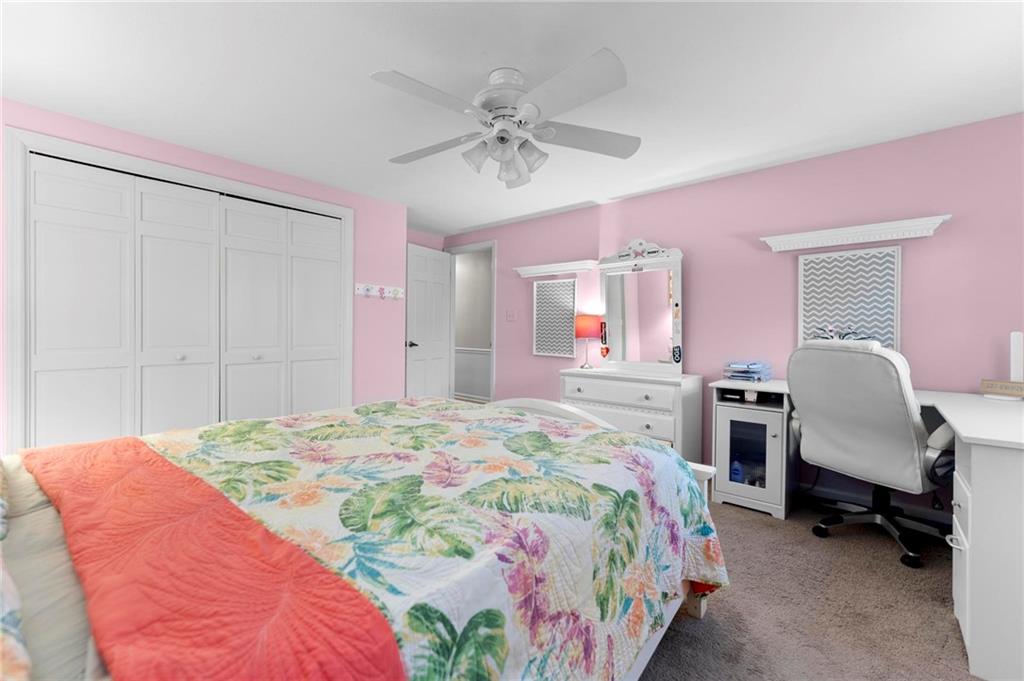 829 Ridgefield Avenue Pittsburgh, PA 15216 - Photo 30 of 50 a spacious bedroom with a bed and a chandelier