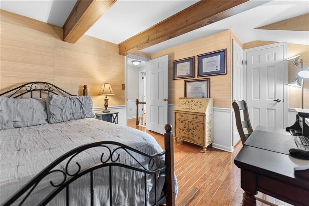 829 Ridgefield Avenue Pittsburgh, PA 15216 - Photo 34 of 50 a bedroom with a bed and wooden floor