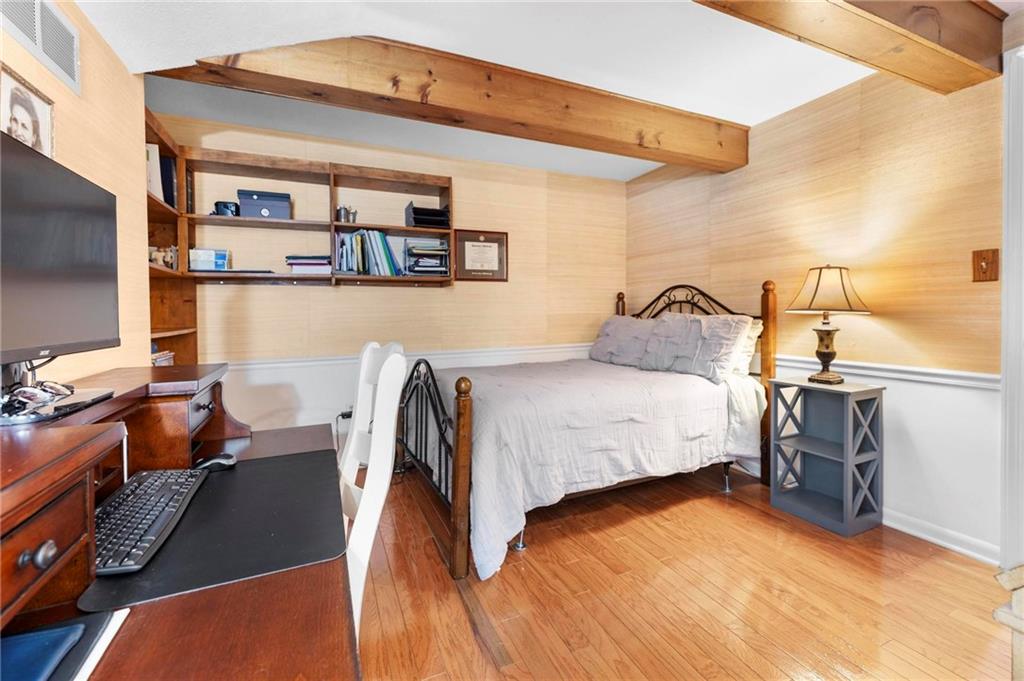 829 Ridgefield Avenue Pittsburgh, PA 15216 - Photo 36 of 50 a bedroom with a bed and dresser with wooden floor