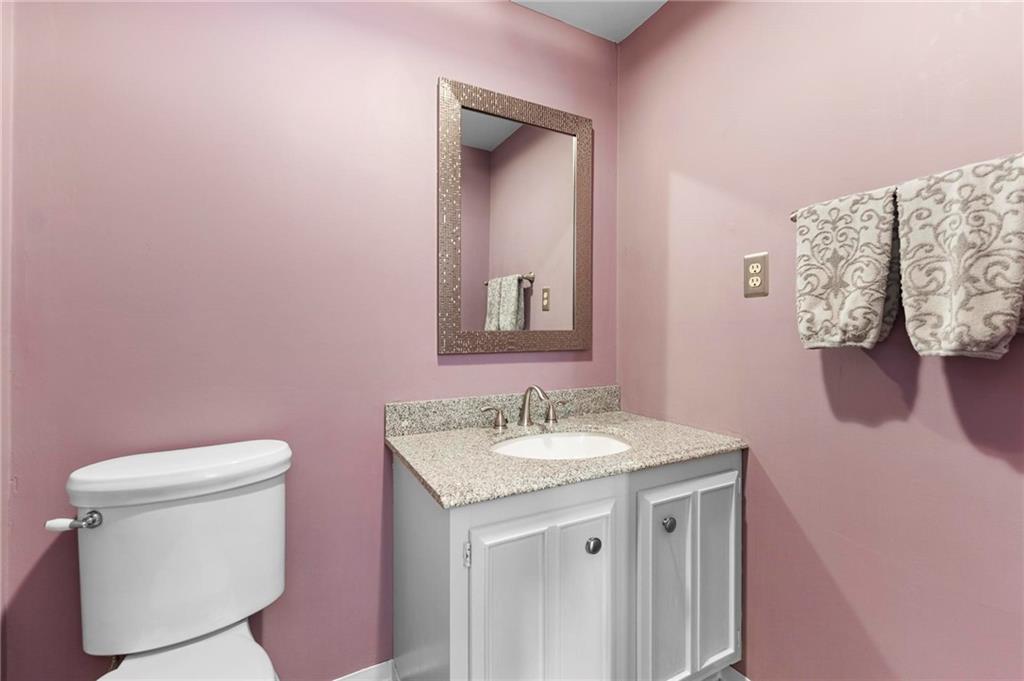 829 Ridgefield Avenue Pittsburgh, PA 15216 - Photo 42 of 50 a bathroom with a granite countertop sink a toilet and mirror