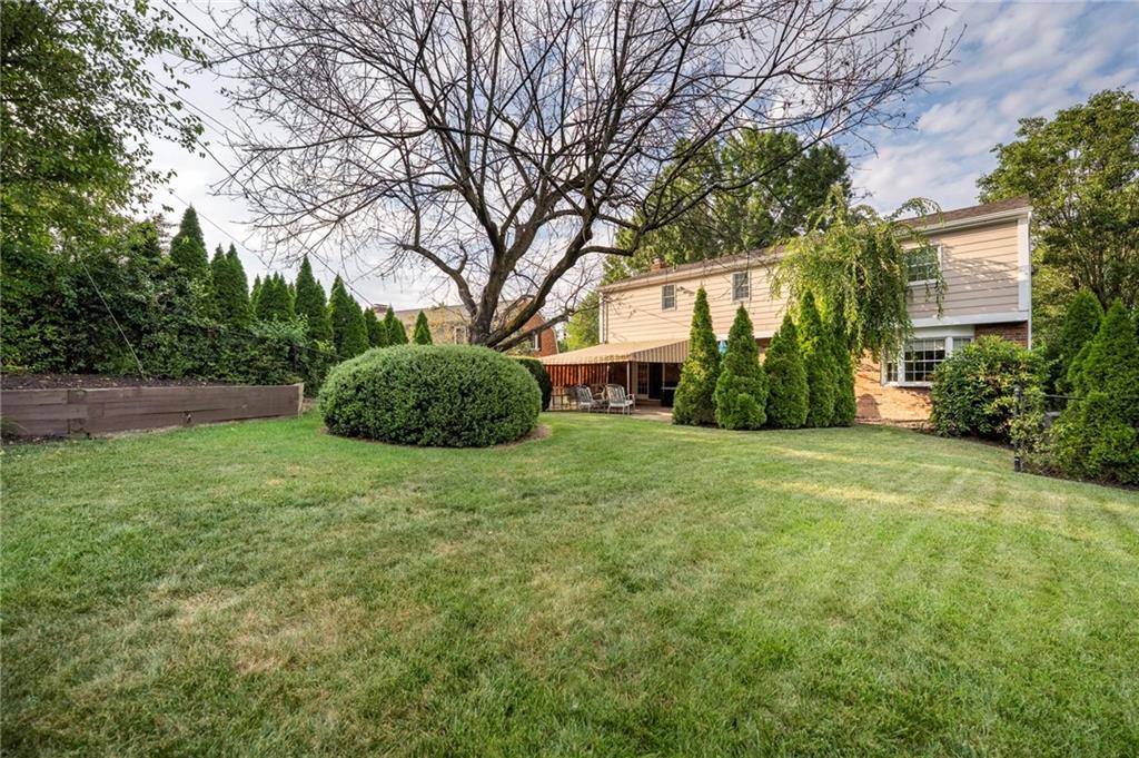 829 Ridgefield Avenue Pittsburgh, PA 15216 - Photo 46 of 50 a backyard of a house with plants and large trees