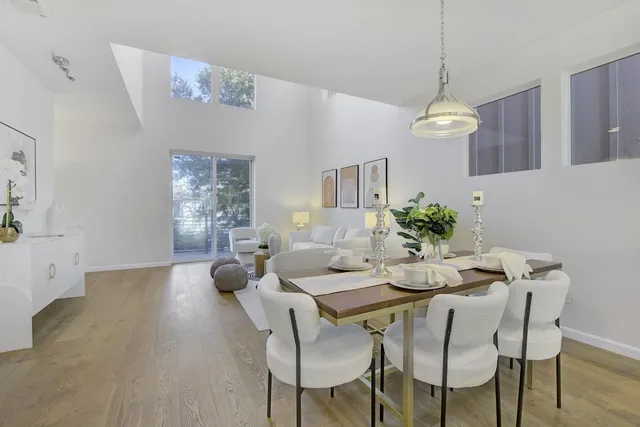 a view of a dining room with furniture wooden floor and chandelier