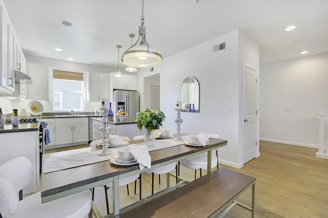 a view of a dining room with furniture and wooden floor