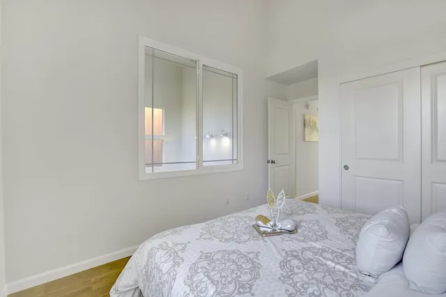 a bedroom with a bed and a window