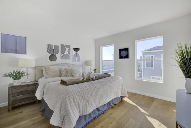 a bedroom with a bed and wooden floor