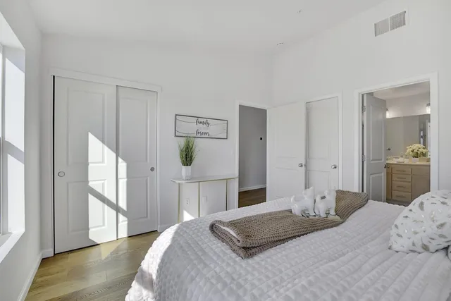 a bedroom with a bed and a mirror