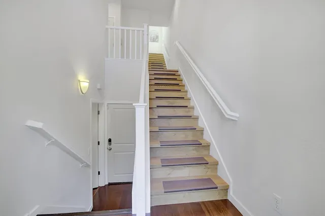 a view of an entryway with wooden floor