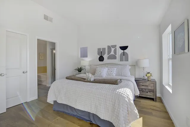 a bedroom with a bed and a lamp