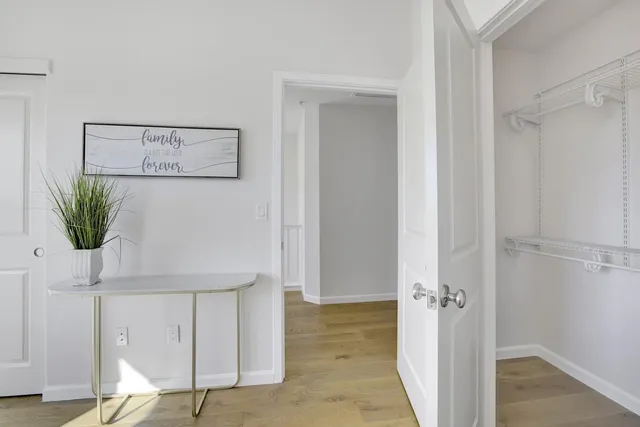 a view of hallway with wooden floor
