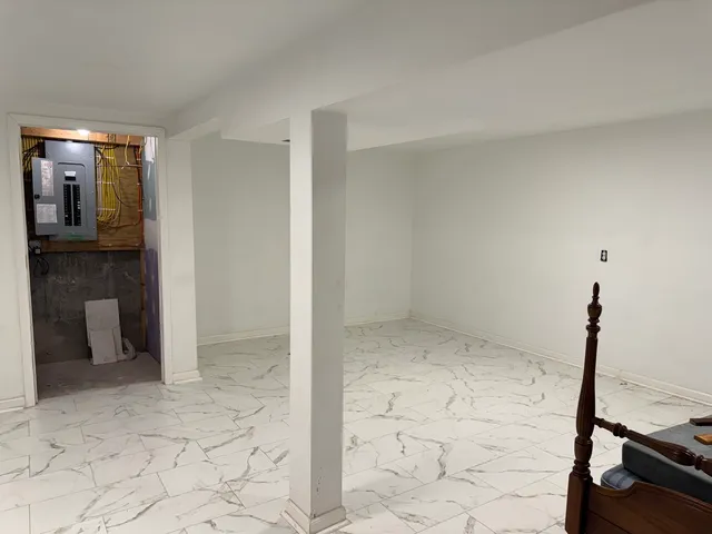 a bathroom with a granite countertop toilet and a sink